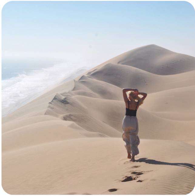 Student posing in the desert on study abroad trip in Namibia